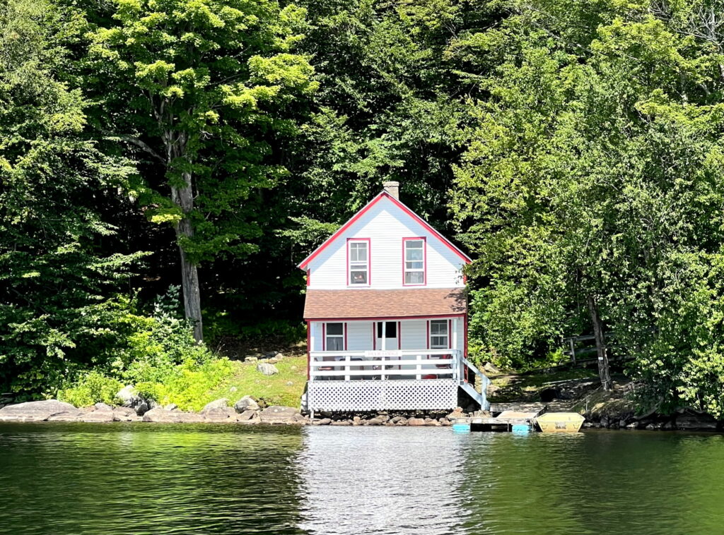 Camp 3 - White, two story camp on the shoreline of Pecks Lake; complete with dock.